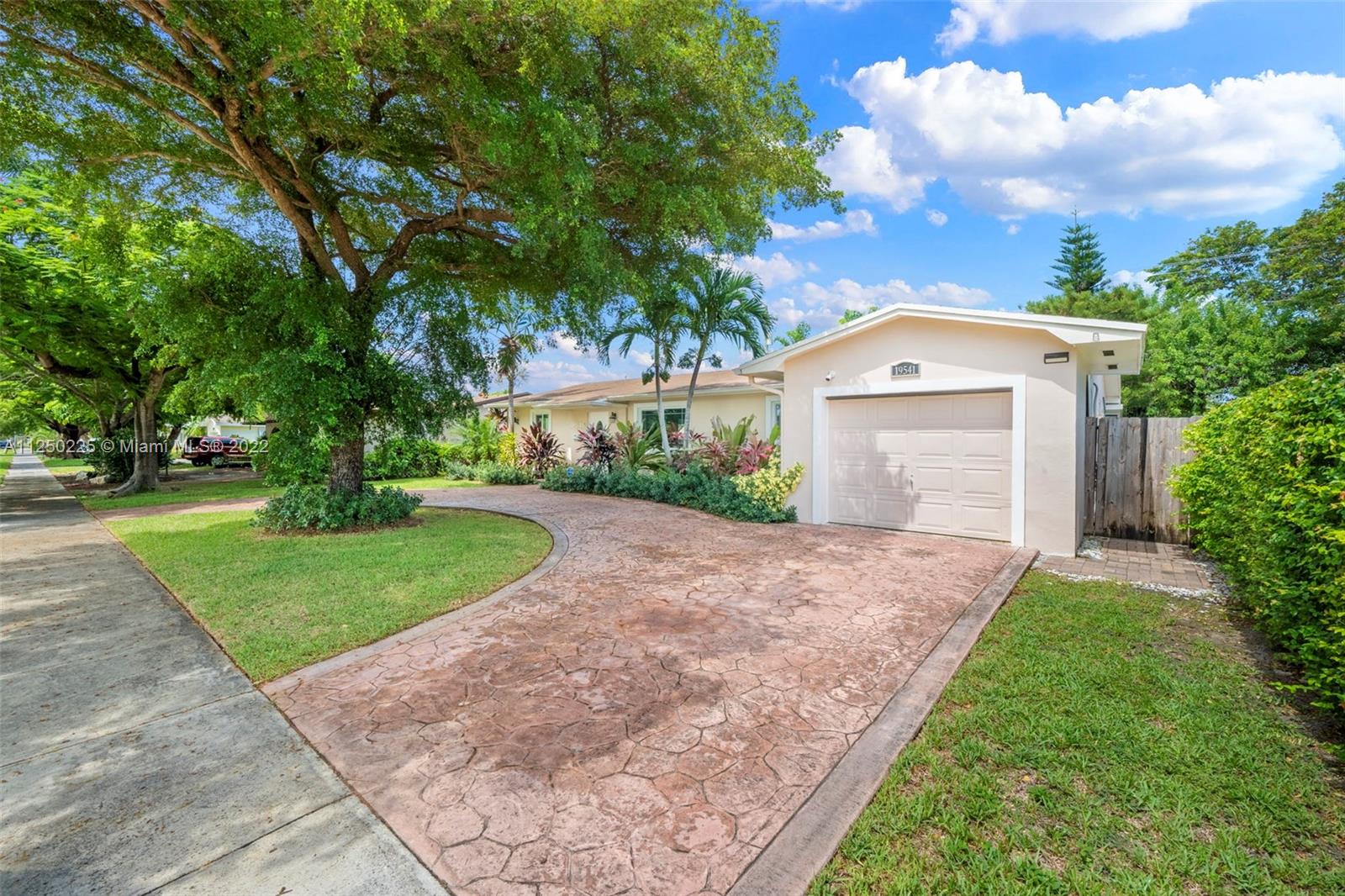 19541 Franjo Road Cutler Bay, FL 33157 - Photo 3 of 28 a front view of a house with a yard and garage