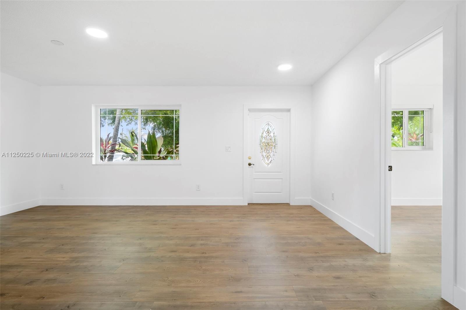 19541 Franjo Road Cutler Bay, FL 33157 - Photo 4 of 28 wooden floor in an empty room with a window
