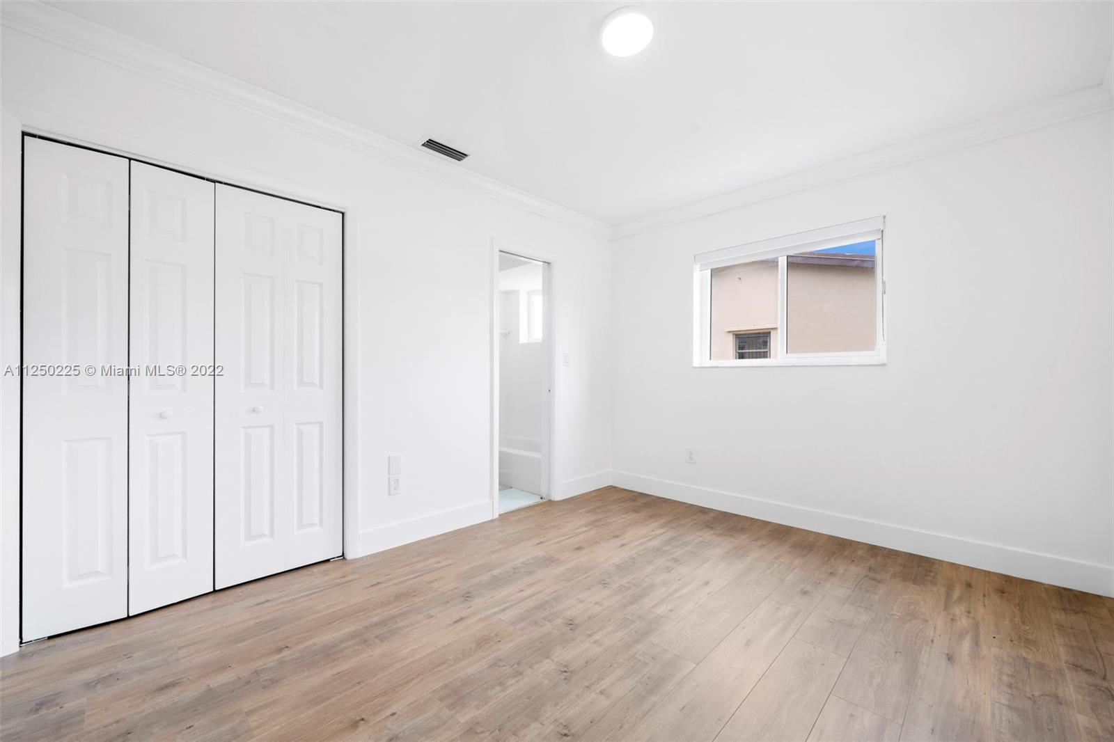 19541 Franjo Road Cutler Bay, FL 33157 - Photo 9 of 28 a view of an empty room with wooden floor