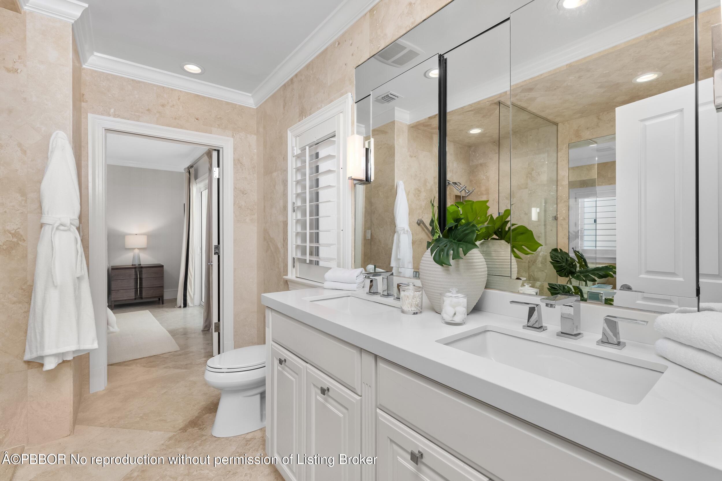 273 List Road Palm Beach, FL 33480 - Photo 15 of 54 a bathroom with a sink a toilet and a large mirror