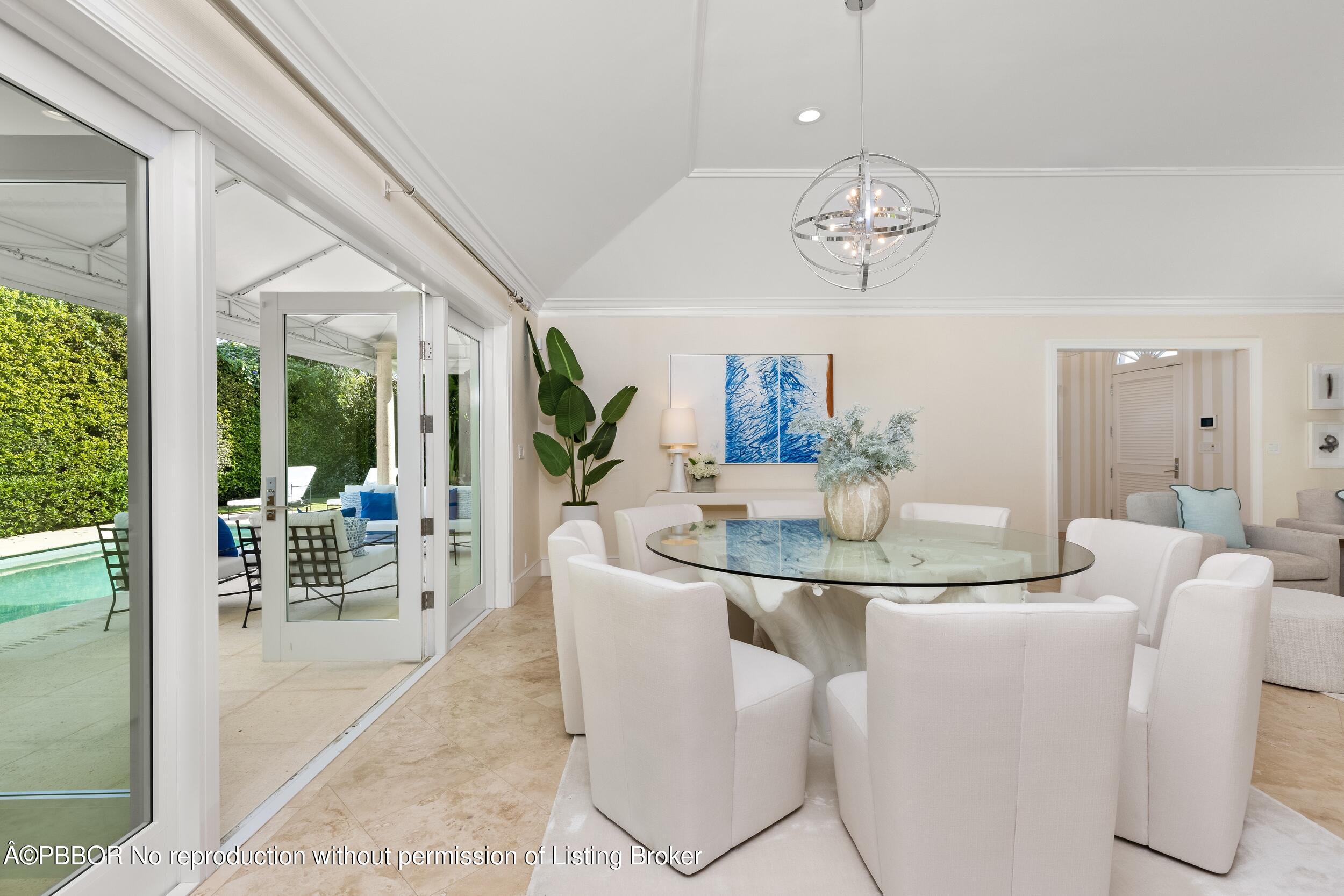 273 List Road Palm Beach, FL 33480 - Photo 20 of 54 a dining room with furniture wooden floor and a chandelier