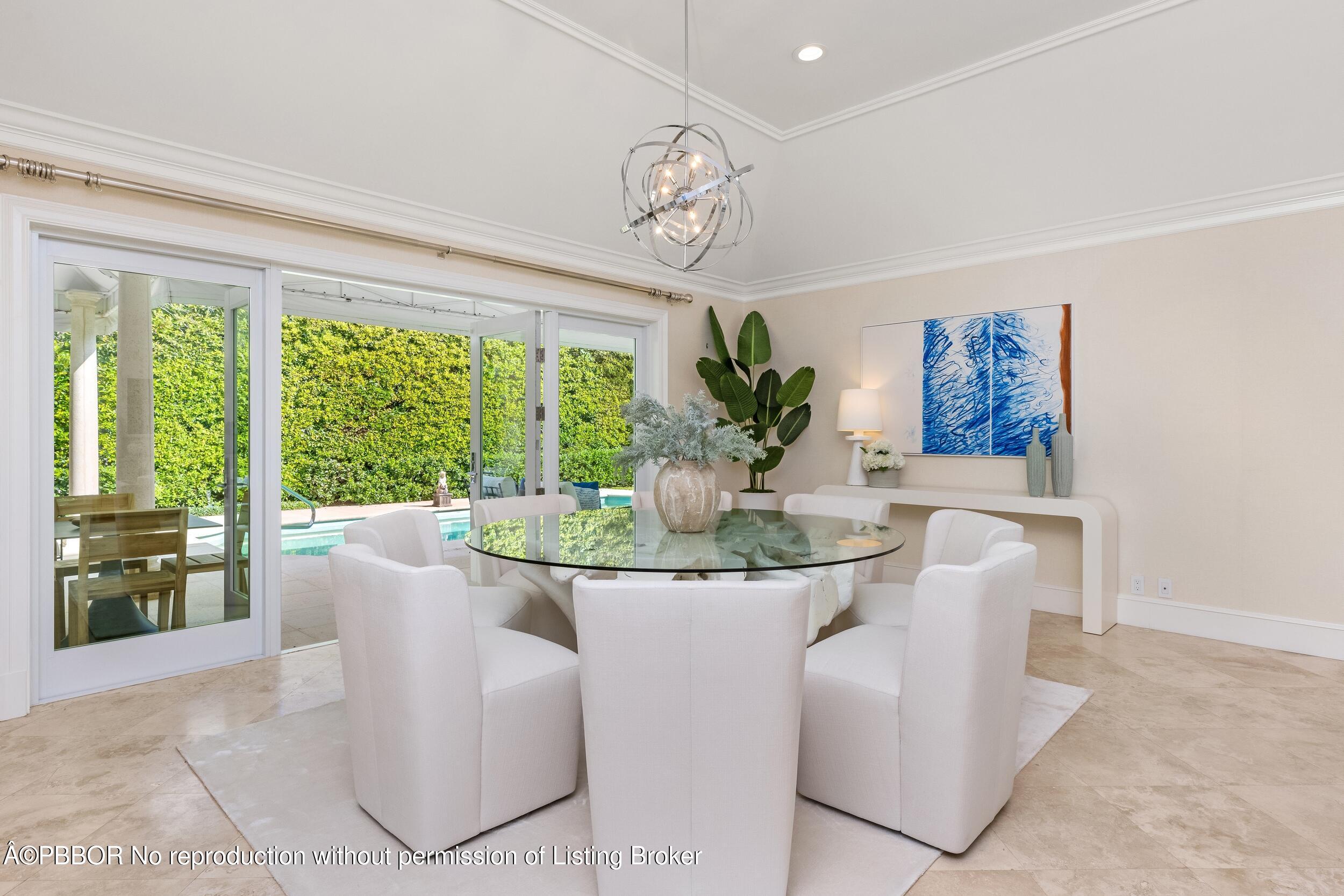 273 List Road Palm Beach, FL 33480 - Photo 21 of 54 a view of a dining room with furniture a chandelier and a fireplace