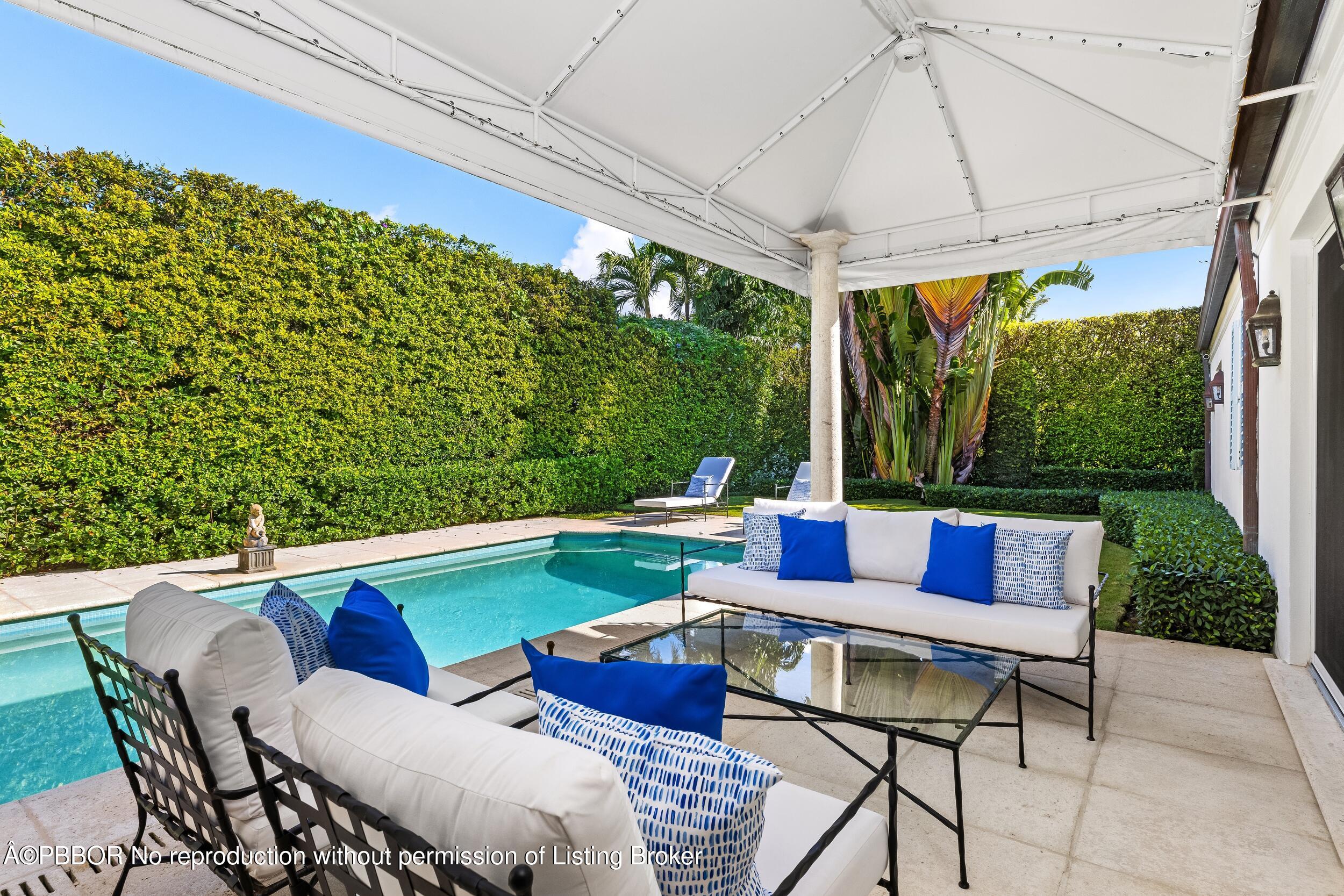 273 List Road Palm Beach, FL 33480 - Photo 24 of 54 a roof deck with table and chairs under an umbrella