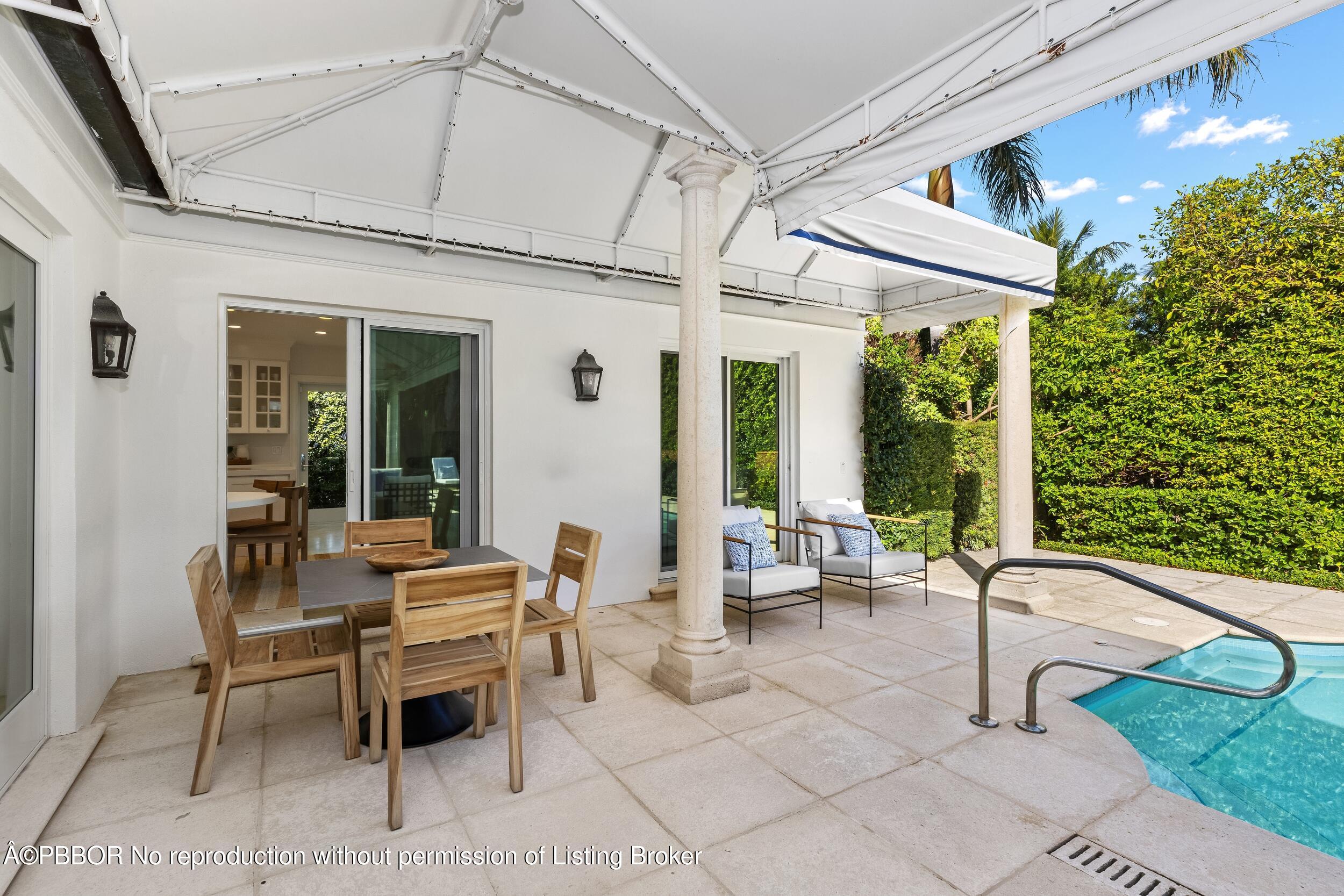 273 List Road Palm Beach, FL 33480 - Photo 25 of 54 a building outdoor space with patio furniture and potted plants