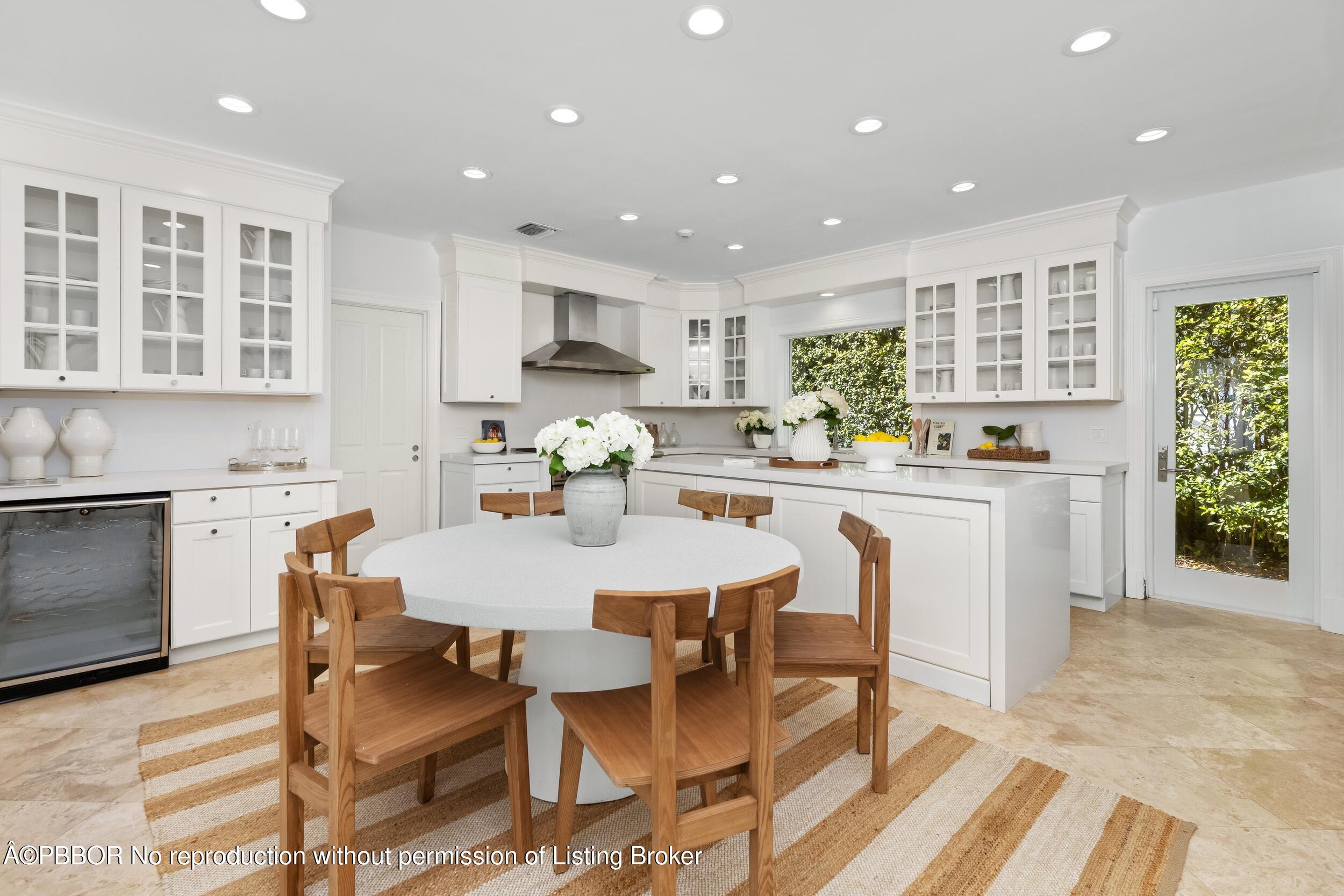 273 List Road Palm Beach, FL 33480 - Photo 27 of 54 a kitchen with stainless steel appliances kitchen island granite countertop a stove a sink a dining table and chairs
