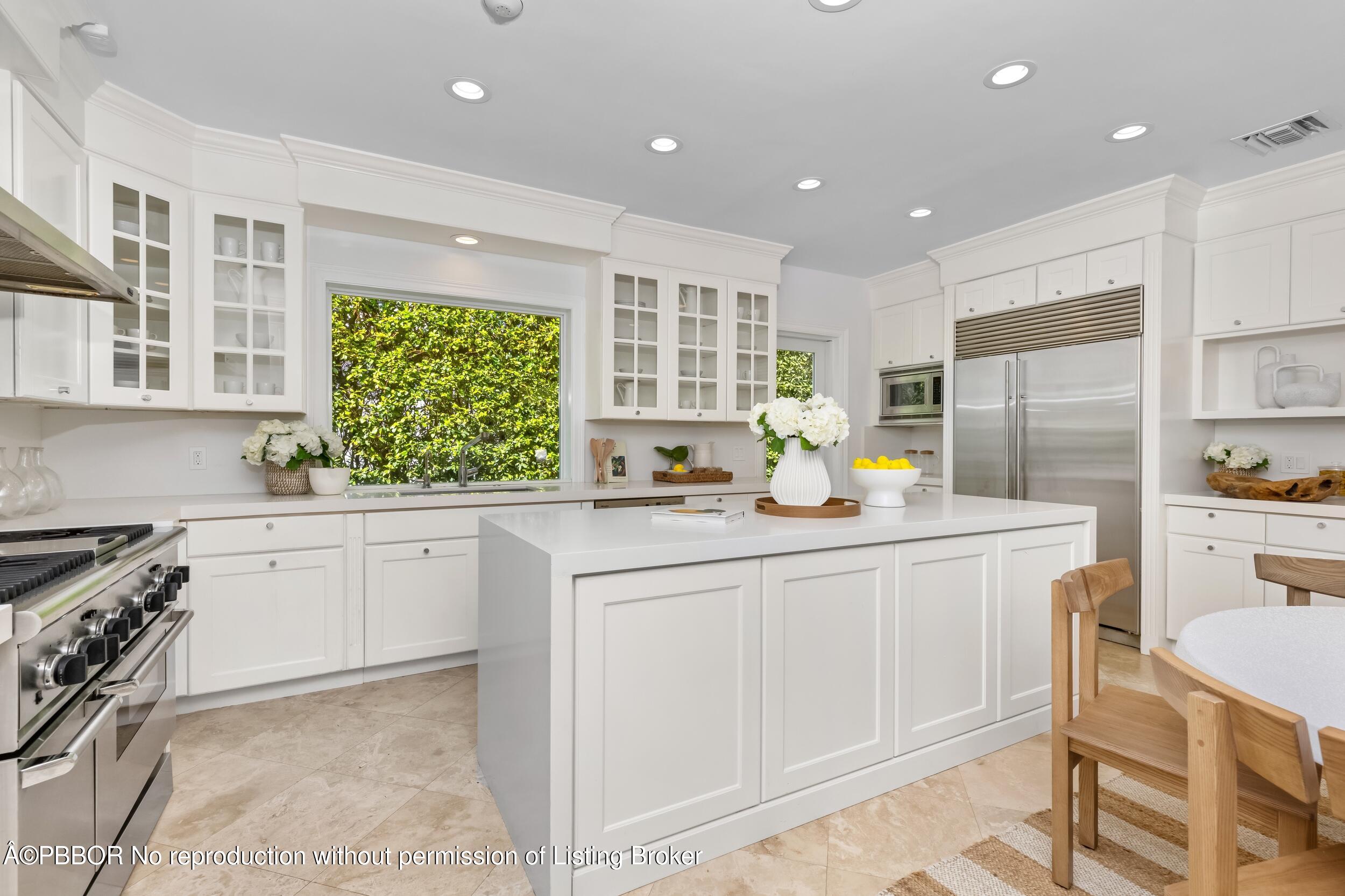 273 List Road Palm Beach, FL 33480 - Photo 31 of 54 a kitchen with stainless steel appliances granite countertop a stove a sink a refrigerator and white cabinets with wooden floor