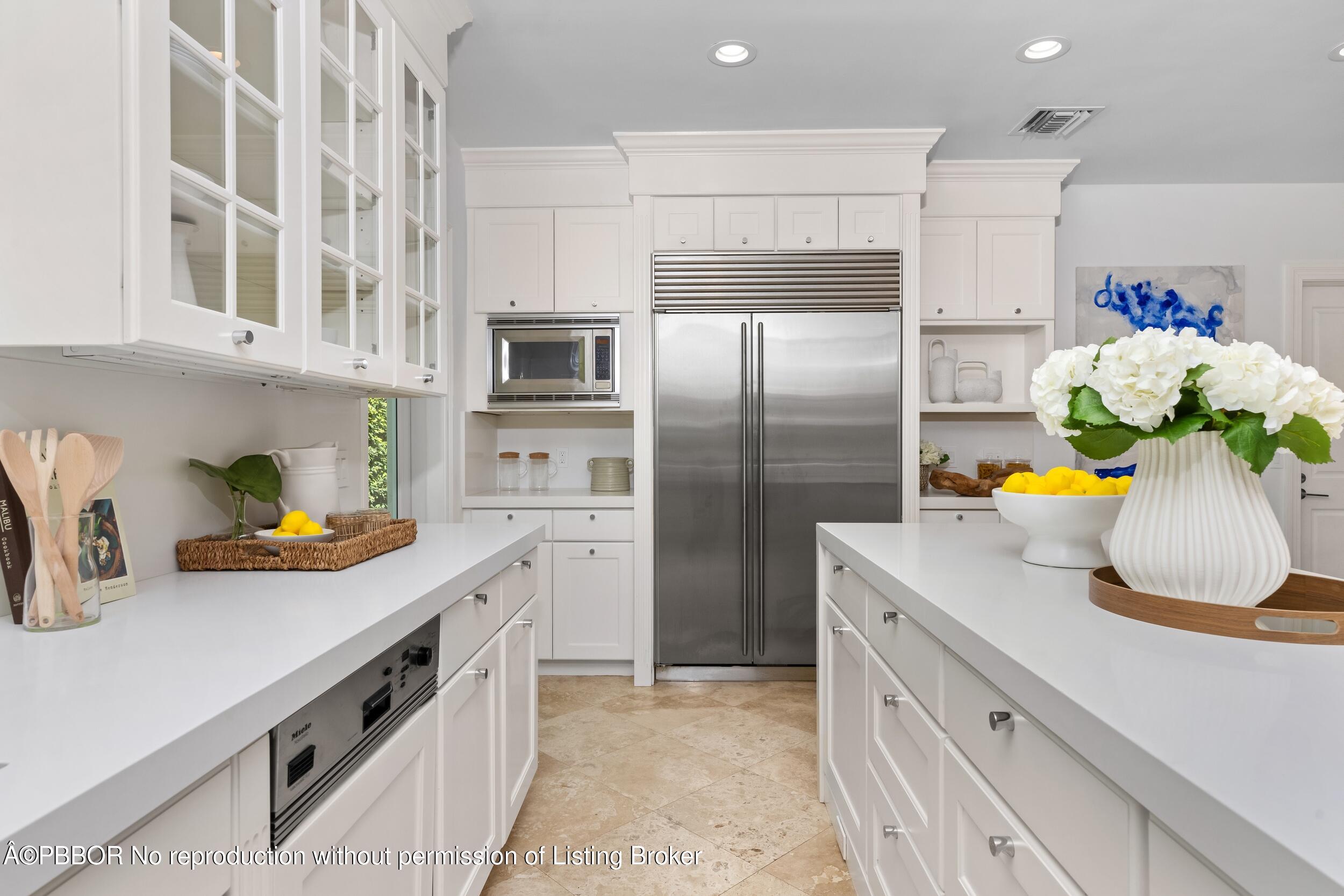 273 List Road Palm Beach, FL 33480 - Photo 32 of 54 a kitchen with stainless steel appliances a sink a refrigerator and a cabinets