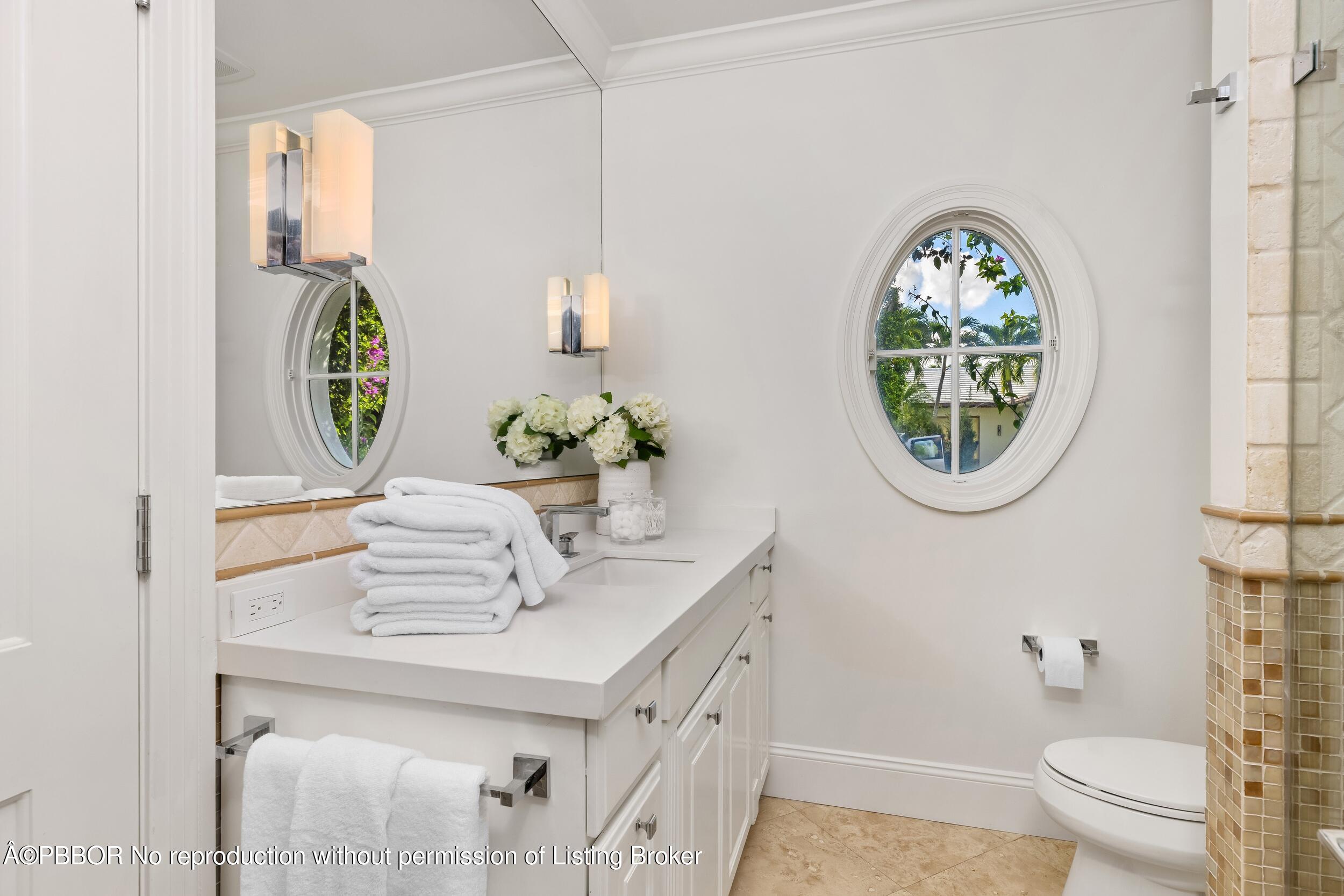 273 List Road Palm Beach, FL 33480 - Photo 37 of 54 a bathroom with a sink a mirror and a toilet