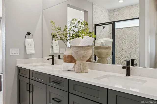 a bathroom with a granite countertop sink toilet and shower