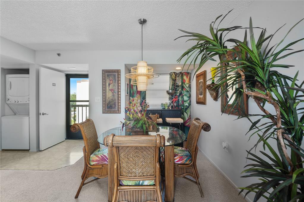 9860 62nd Avenue North, Unit 1047 St. Petersburg, FL 33708 - Photo 11 of 34 a view of a livingroom with furniture and a floor to ceiling window