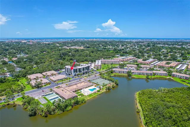 a view of a city with lawn chairs under an umbrella