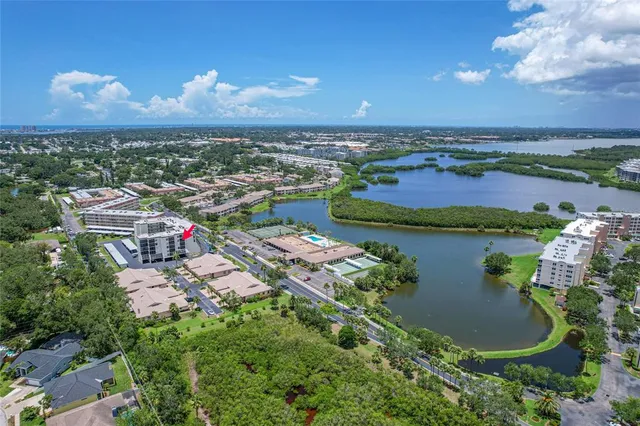 an aerial view of residential houses with outdoor space and ocean view
