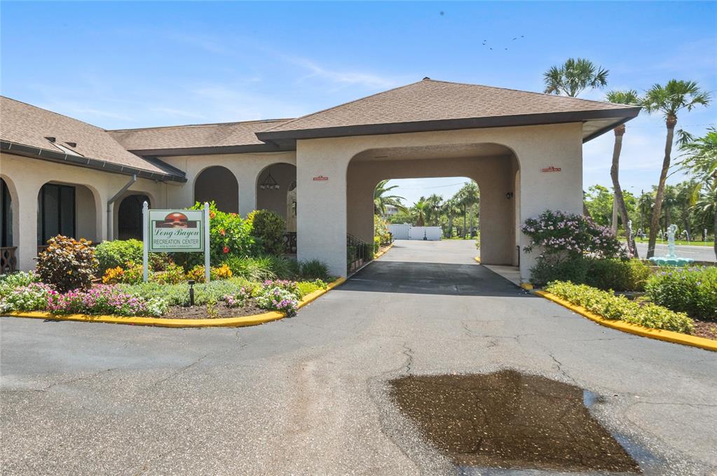 9860 62nd Avenue North, Unit 1047 St. Petersburg, FL 33708 - Photo 19 of 34 a front view of a house with a yard