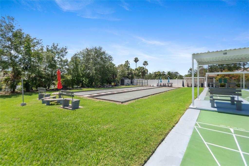 9860 62nd Avenue North, Unit 1047 St. Petersburg, FL 33708 - Photo 26 of 34 a park view with a bench