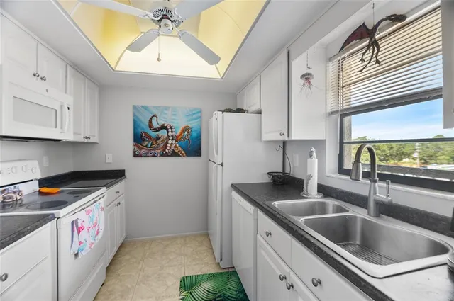 a kitchen that has a sink and a stove in it