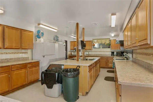 a kitchen with sink stove and cabinets