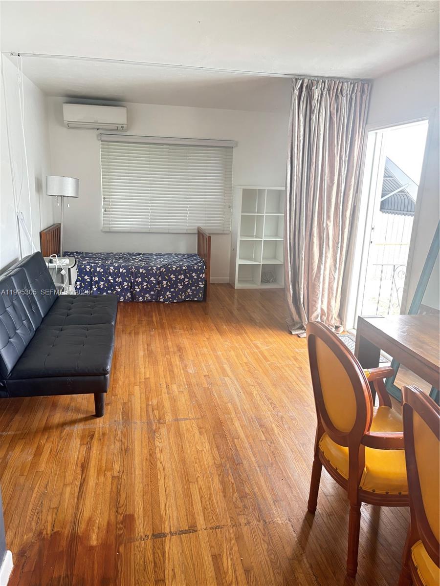 2951 Southwest 23rd Street, Unit 2 Miami, FL 33145 - Photo 5 of 7 a living room with a couch and wooden floor