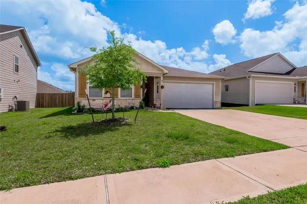 a kitchen with granite countertop a refrigerator and a stove top oven