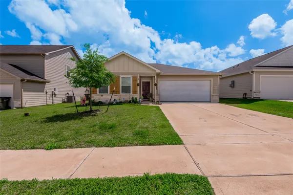 a kitchen with white cabinets and refrigerator