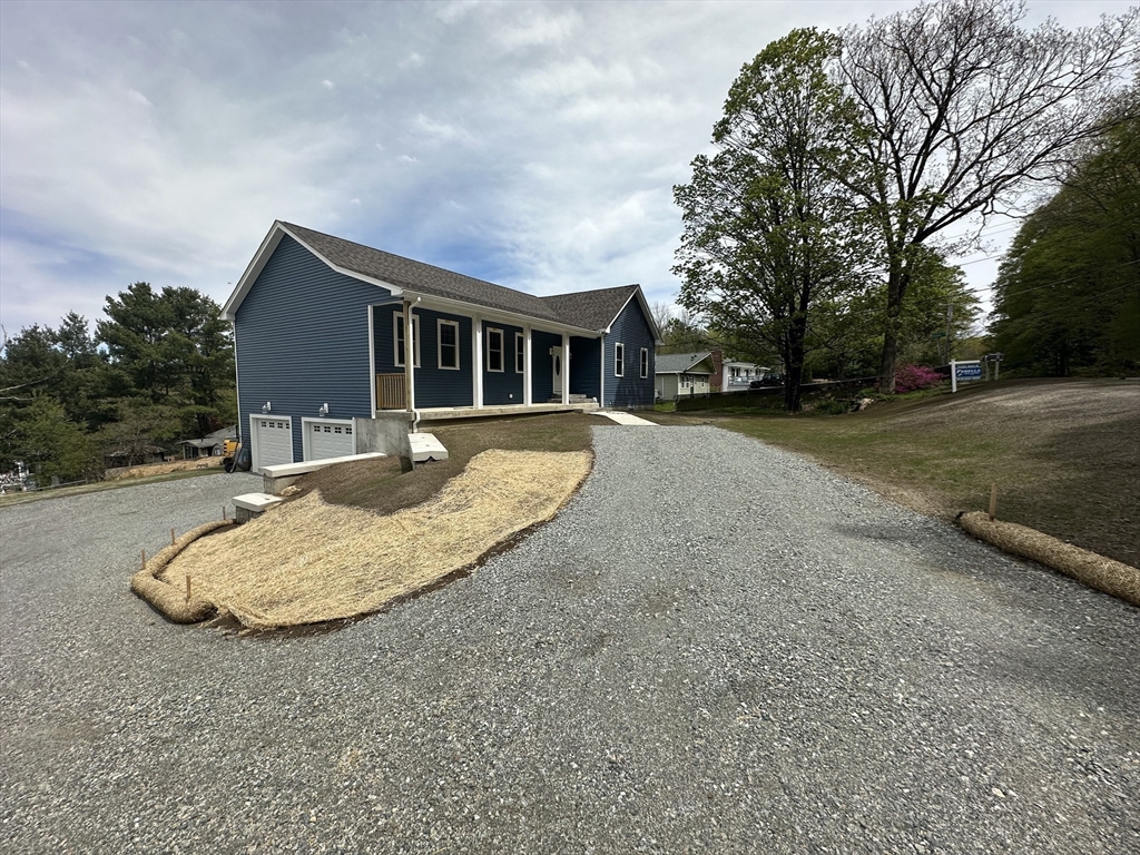 88 Stafford Holland Road Wales, MA 01081 - Photo 7 of 31 a front view of house with yard and trees around
