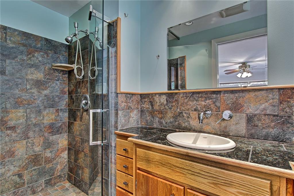 9376 Woodcrest Road Pittsburgh, PA 15237 - Photo 12 of 24 Master bath features a tiled surround shower & glass door; coordinating backsplash, and granite-topped custom built vanity.