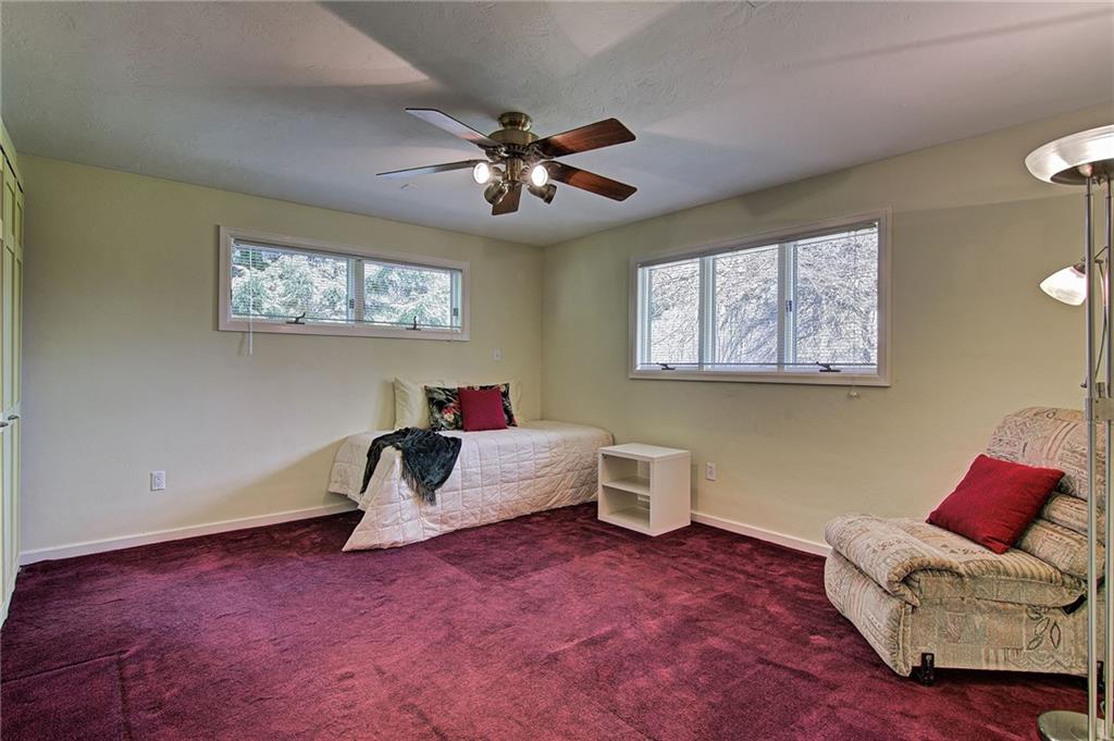 9376 Woodcrest Road Pittsburgh, PA 15237 - Photo 15 of 24 Bedroom #2 features a lighted ceiling fan and windows for plenty of natural light. The stacking laundry is housed its extra deep closet