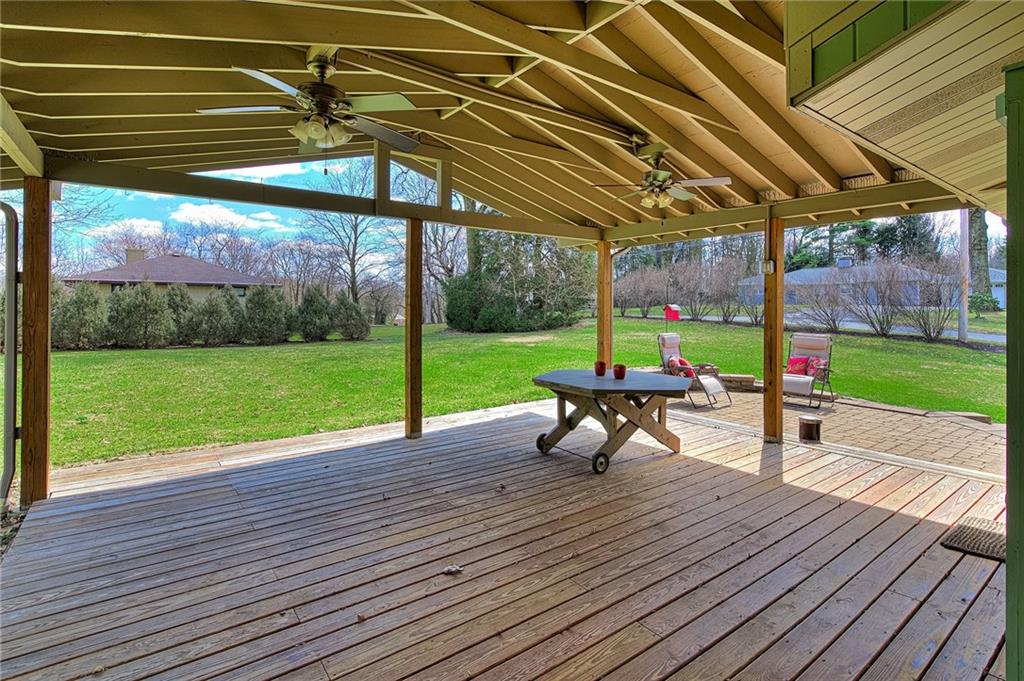 9376 Woodcrest Road Pittsburgh, PA 15237 - Photo 23 of 24 Vaulted ceiling features two fans and there's plenty of space for seating. Two entrances to the home from the covered deck make entertaining a breeze! Under the wood is a concrete pad.