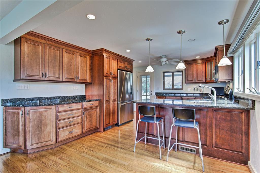 9376 Woodcrest Road Pittsburgh, PA 15237 - Photo 5 of 24 Sensational KraftMaid cabinets with soft-close drawers are sure to be a favorite feature. Pendant lighting over the L-shaped island finishes the contemporary look.