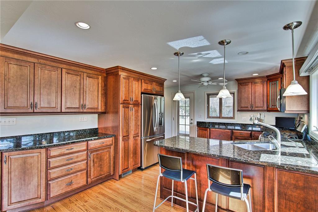 9376 Woodcrest Road Pittsburgh, PA 15237 - Photo 7 of 24 It's easy to see how much natural light floods this kitchen space! Granite gleams throughout and the double sink is positioned to enjoy the views.