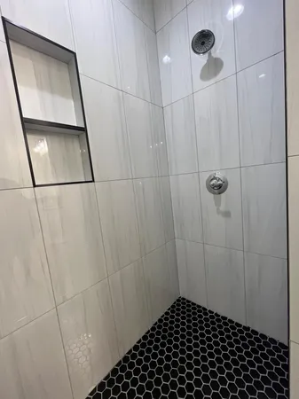 an empty room with a ceiling fan and window