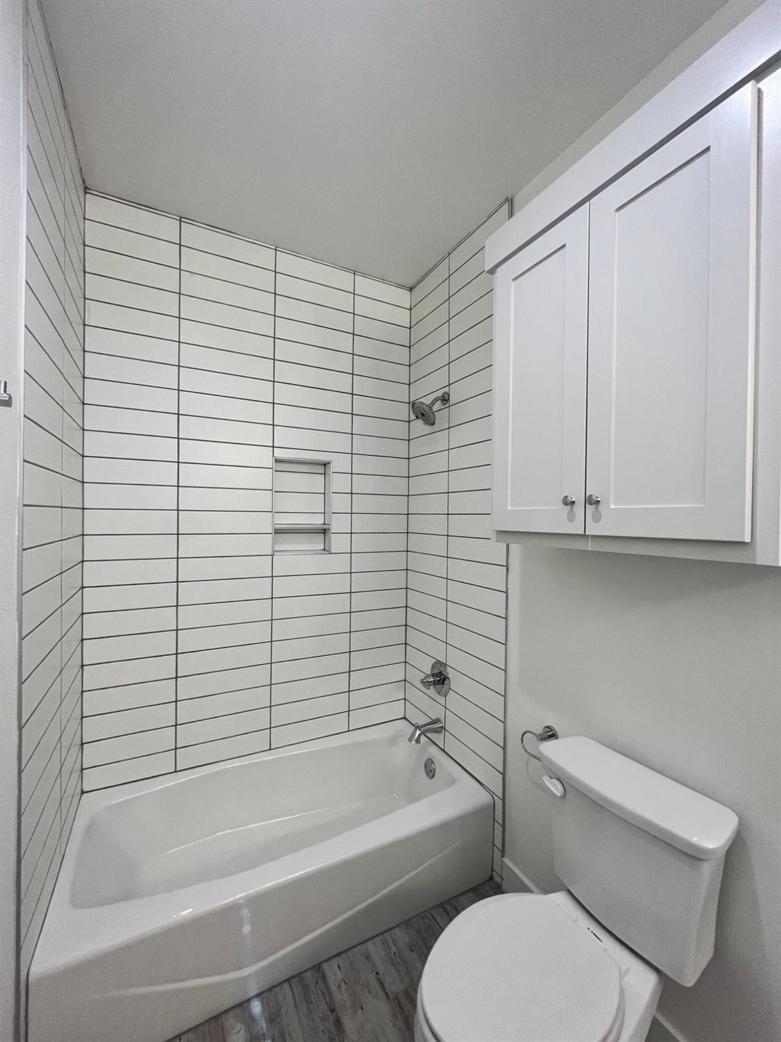 5102 58th Street, Unit 2 Lubbock, TX 79414 - Photo 14 of 18 a bathroom with a toilet and a bathtub