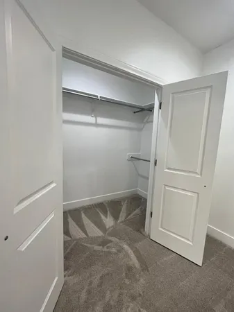 a spacious bathroom with a granite countertop sink and a mirror