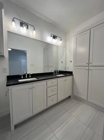 a spacious bathroom with a granite countertop sink a toilet and shower