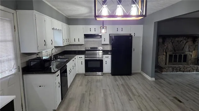 a kitchen with stainless steel appliances granite countertop a stove and a refrigerator