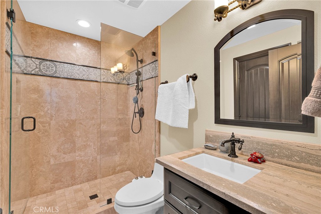 16727 Pienza Court Riverside, CA 92503 - Photo 24 of 41 Main-level bath in custom tile and iron detail