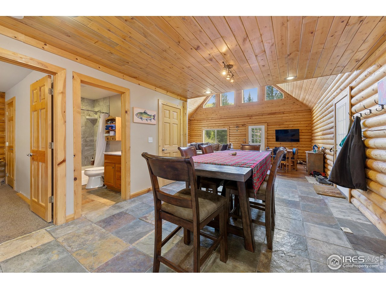 320 Mill Road Eagle, CO 81631 - Photo 11 of 32 a view of a dining room with furniture and a flat screen tv