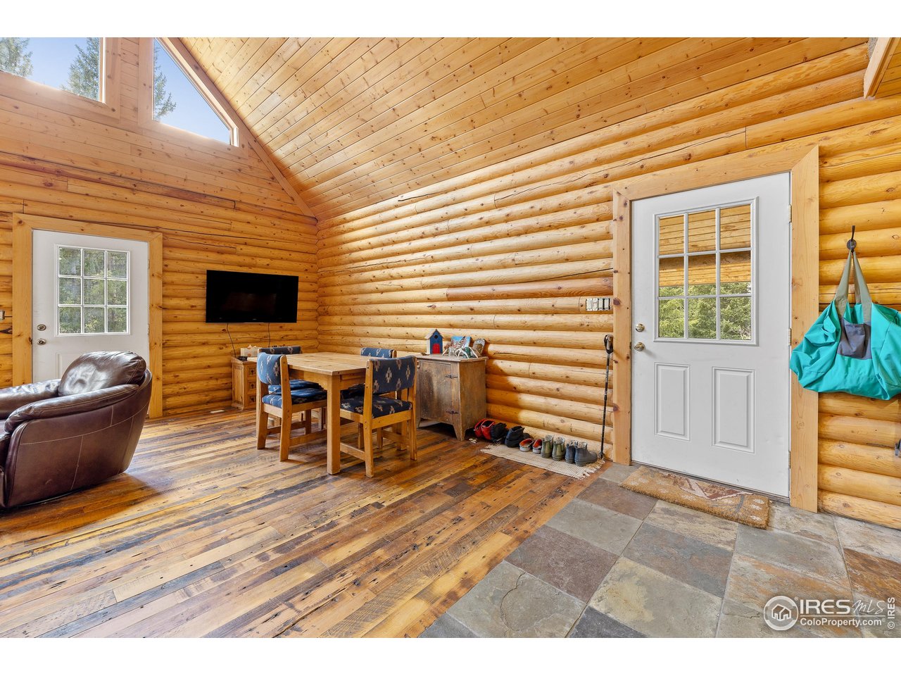 320 Mill Road Eagle, CO 81631 - Photo 14 of 32 a view of a patio with table and chairs with wooden floor and fence
