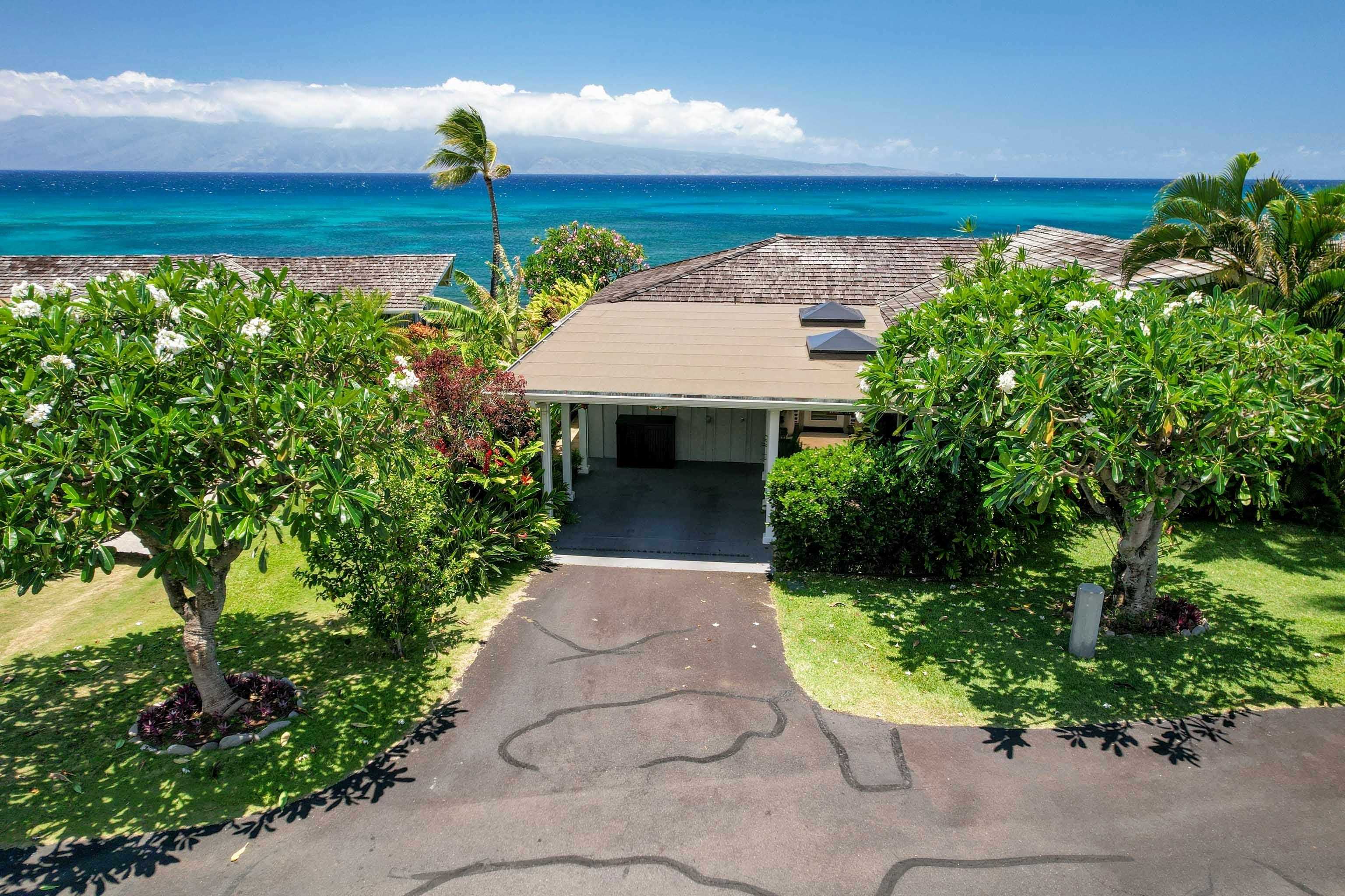 20 Hui Road East, Unit 30 Lahaina, HI 96761 - Photo 24 of 25 a front view of a house with a yard and potted plants