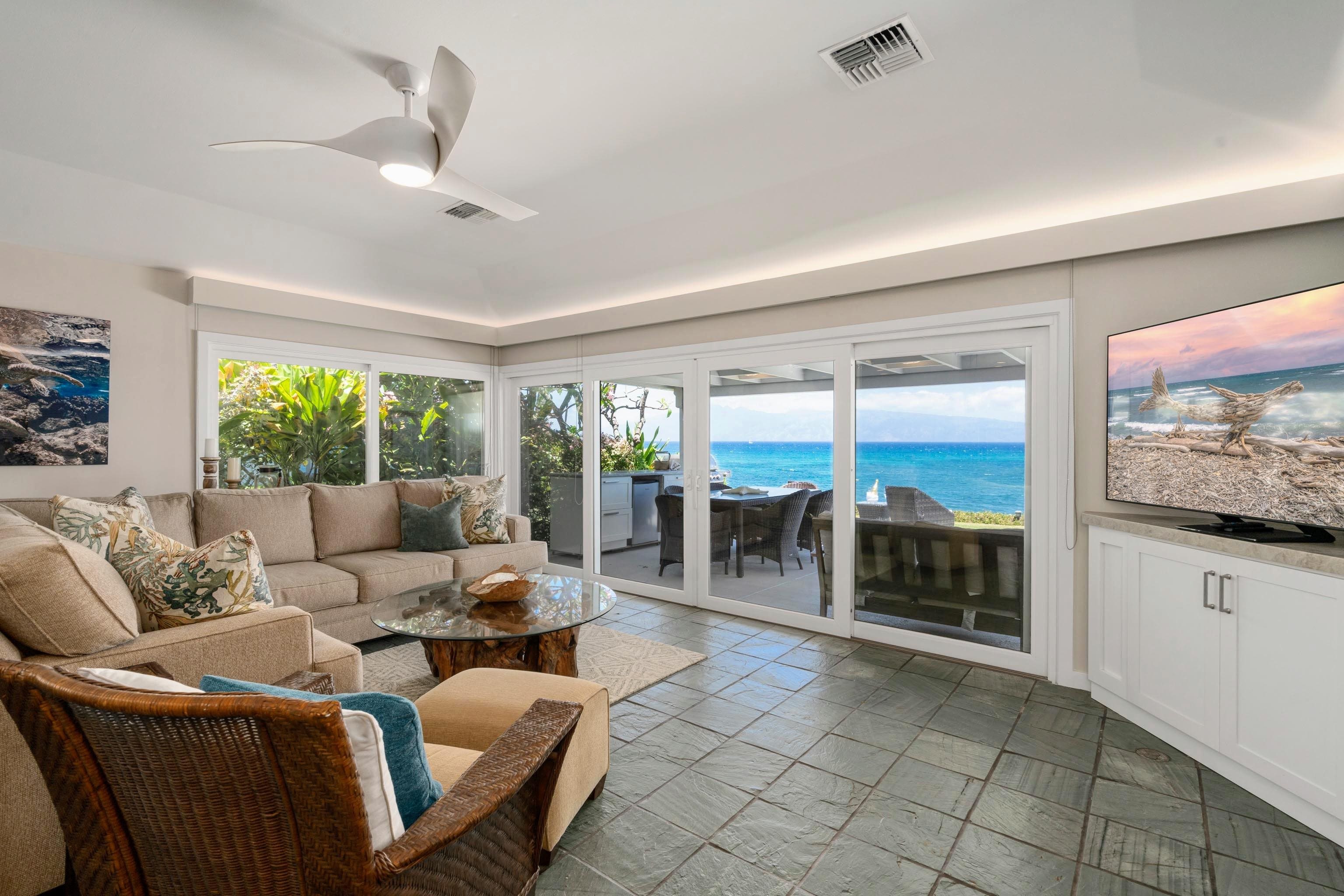 20 Hui Road East, Unit 30 Lahaina, HI 96761 - Photo 10 of 25 a living room with furniture a flat screen tv and floor to ceiling window