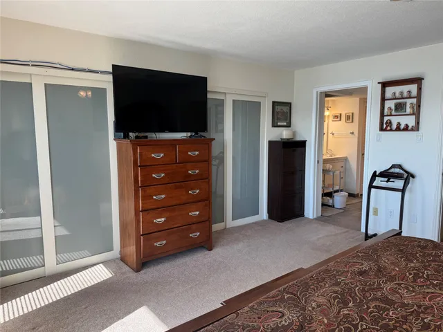 a bathroom with a granite countertop shower and a toilet