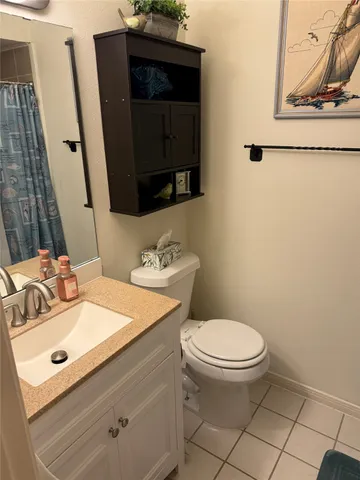 a bathroom with a sink toilet and mirror