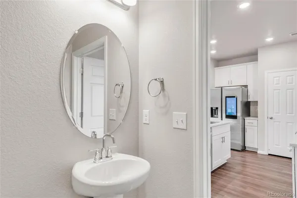 a bathroom with a sink a mirror and shower