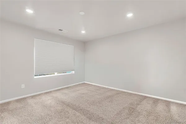an empty room with a empty space and window