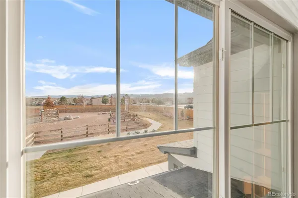 a view of a glass door with a floor to ceiling window next to a yard