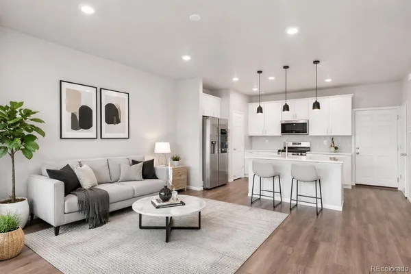 a living room with furniture and kitchen view