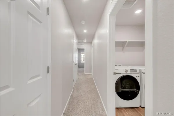 a view of a hallway with washer and dryer