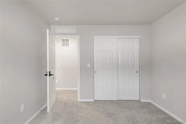 an empty room with closet area