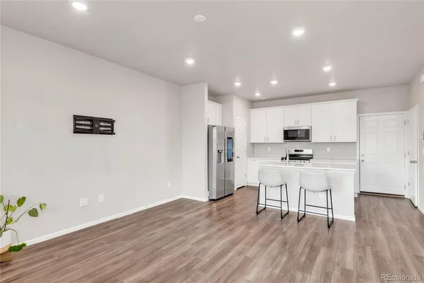 a view of kitchen with stainless steel appliances refrigerator microwave and stove