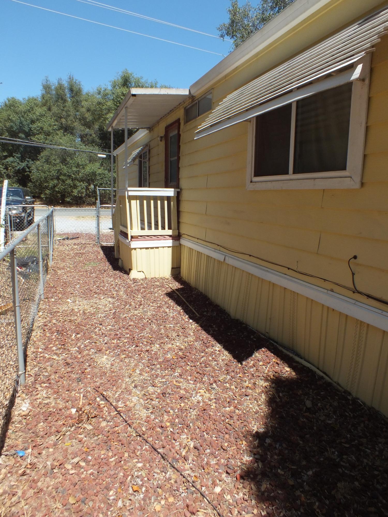 7725 Happy Valley Road, Unit DELUXE Anderson, CA 96007 - Photo 1 of 29 a front view of a house with a yard