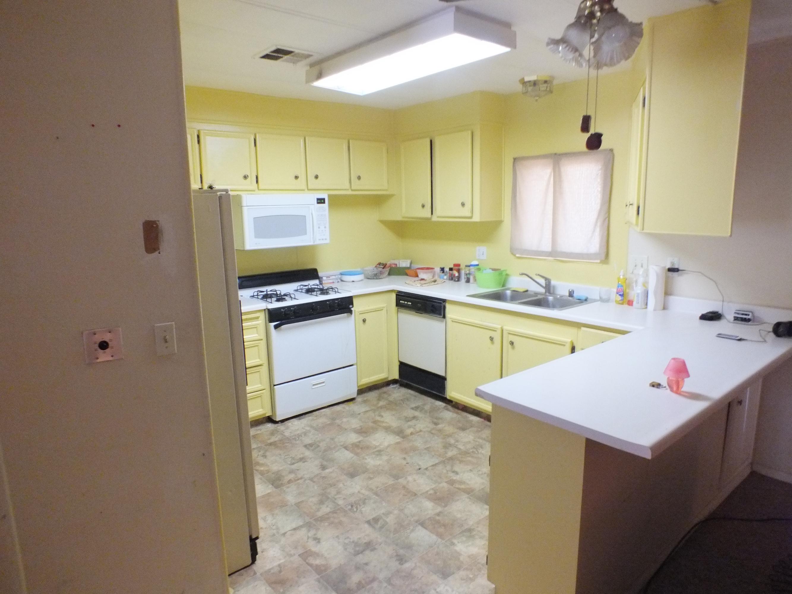 7725 Happy Valley Road, Unit DELUXE Anderson, CA 96007 - Photo 12 of 29 a kitchen with a sink a stove and cabinets
